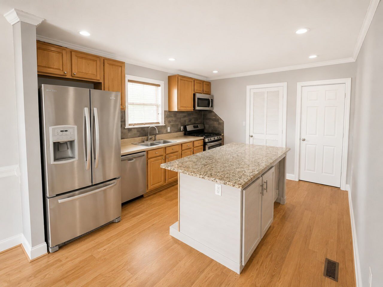 Kitchen with granite island and stainless steel appliances